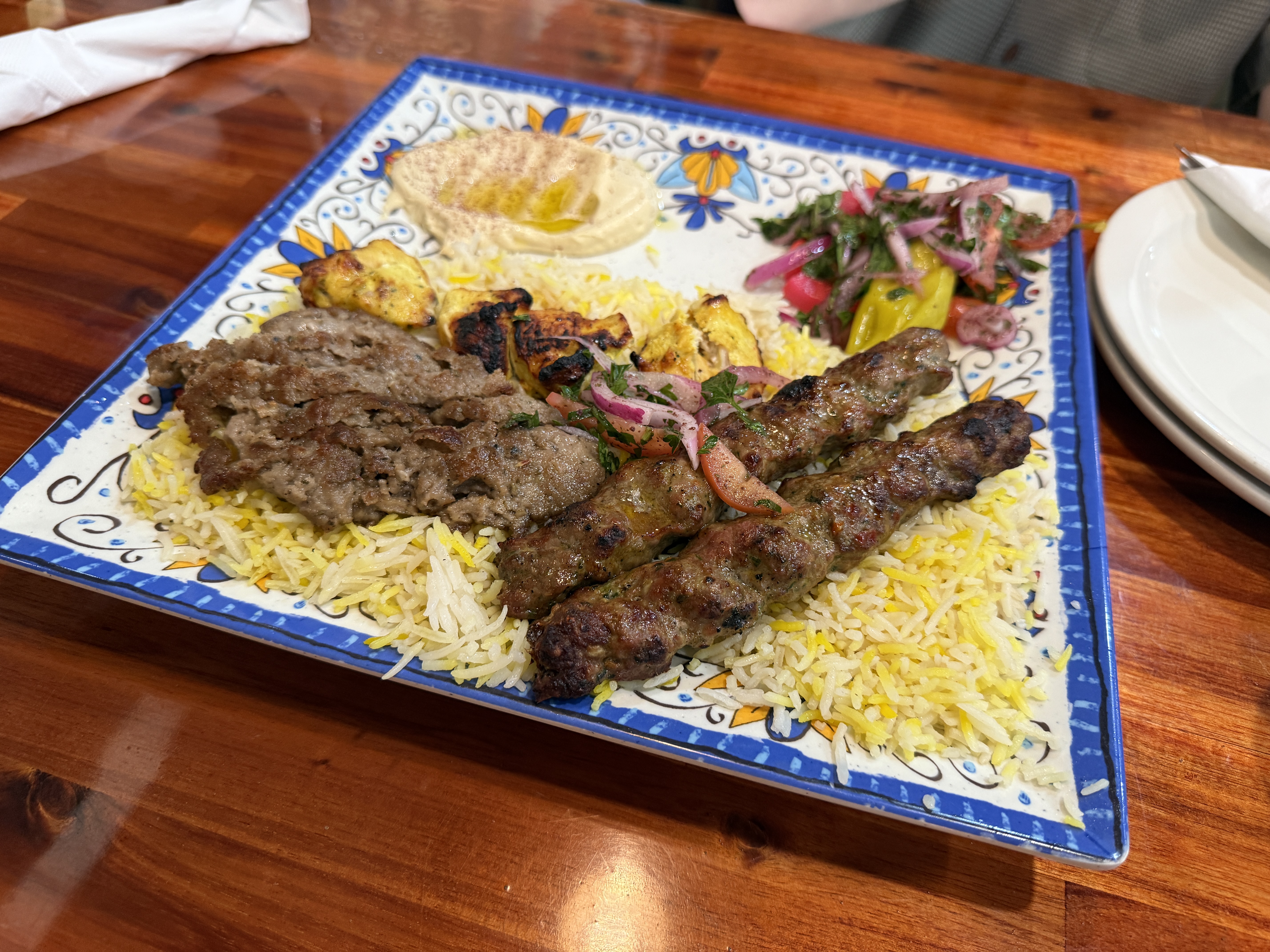 combination platter with beef, lamb, rice, and hummus