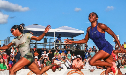 Two African American women running next to each other in a race