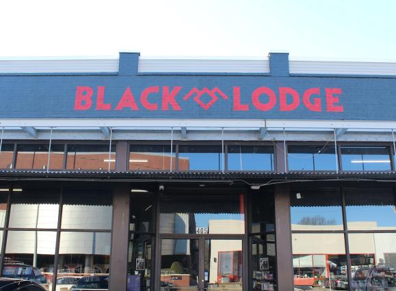 Red and black sign exterior of Black Lodge video rental store 