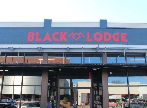 Red and black sign exterior of Black Lodge video rental store 