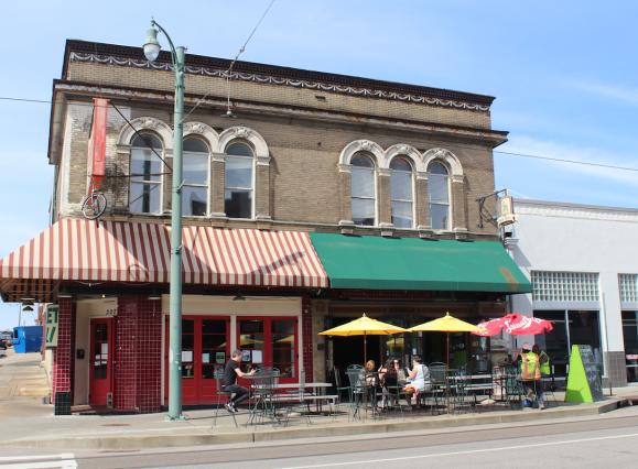 Historic Green Beetle bar building with red and green awning