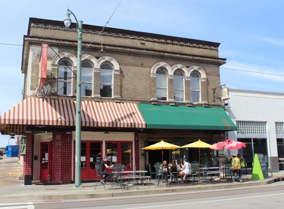 Historic Green Beetle bar building with red and green awning