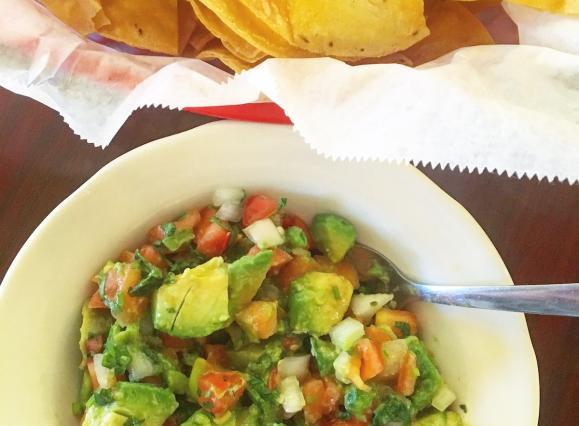 bowl of guacamole and chips