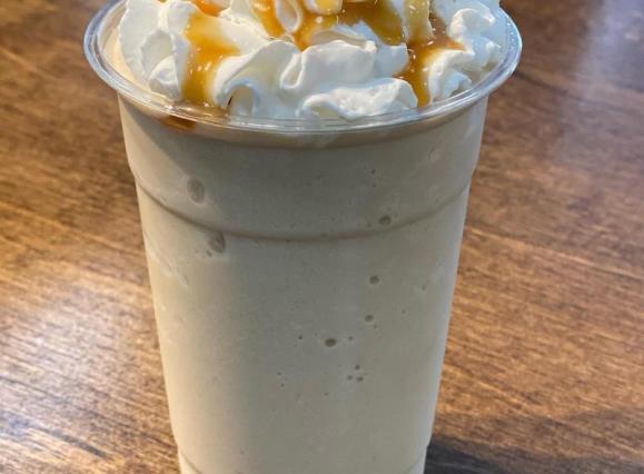 frozen coffee drink with whipped cream and caramel drizzle