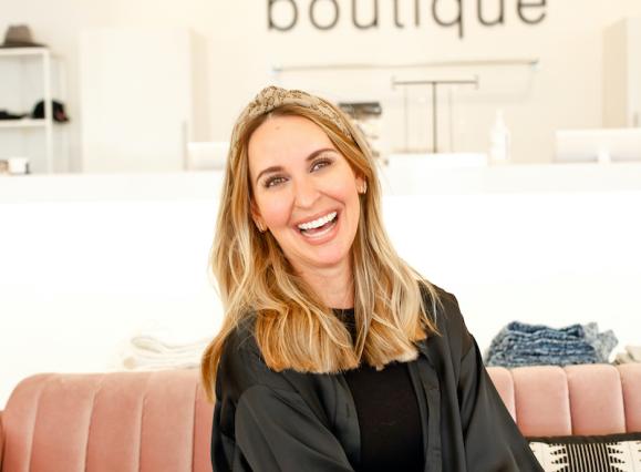 portrait of women on a couch in a boutique, Mozelle Sign on the wall