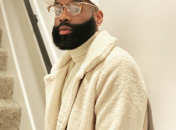 musician dress in a white coat and white hat with a beard