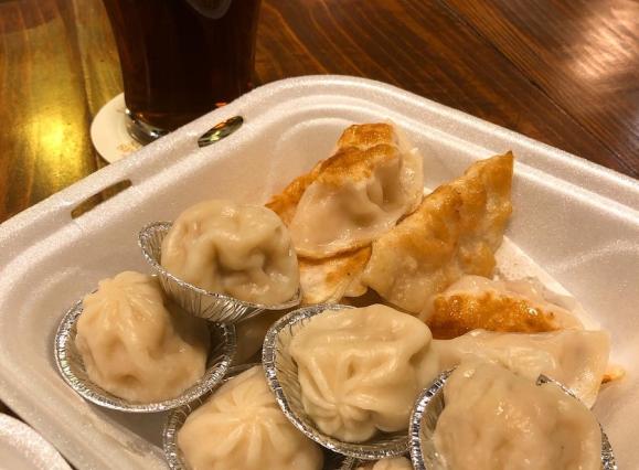 soup dumplings and potstickers with a dark beer
