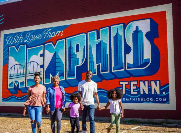Multigenerational family in front Edge District Memphis mural | The Traveling Child