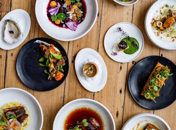 many plates of different sizes with different types of food