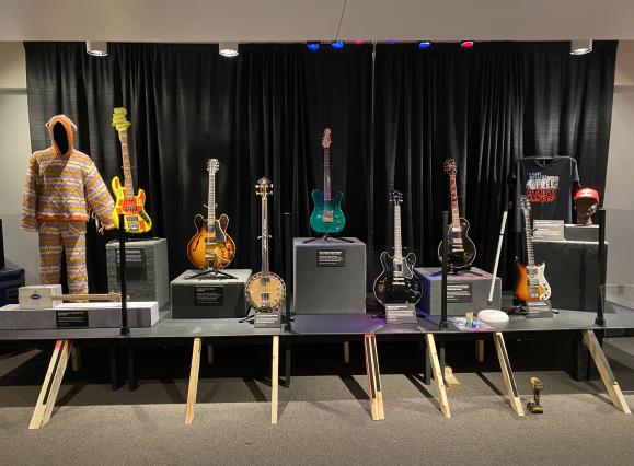 7 guitars on display, all different kinds but