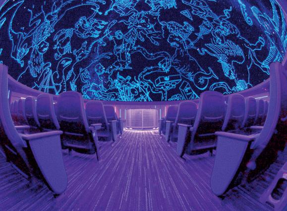 Wide shot of planetarium at MoSH with empty seats and ceiling lit up