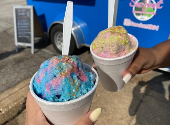 two snow cones in blue and pink with edible glitter