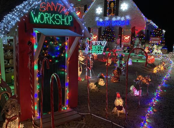 home decorated with christmas lights and Santa house