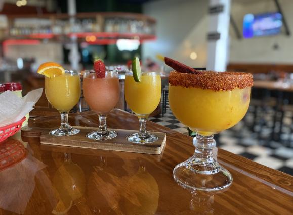 margarita flight next to large mango margarita