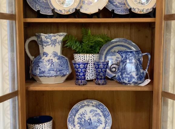white and blue china on display