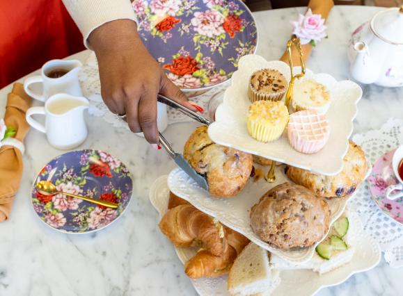 afternoon tea setup with tea pots and treats