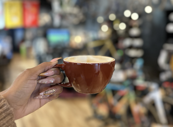coffee held up in store with background blurred