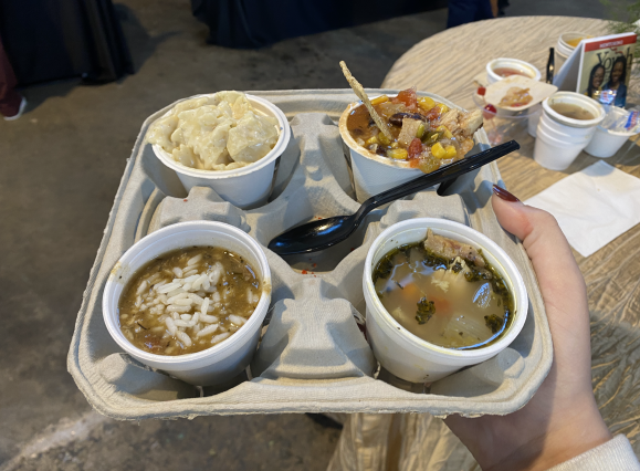 four varieties of soup on a drink holder
