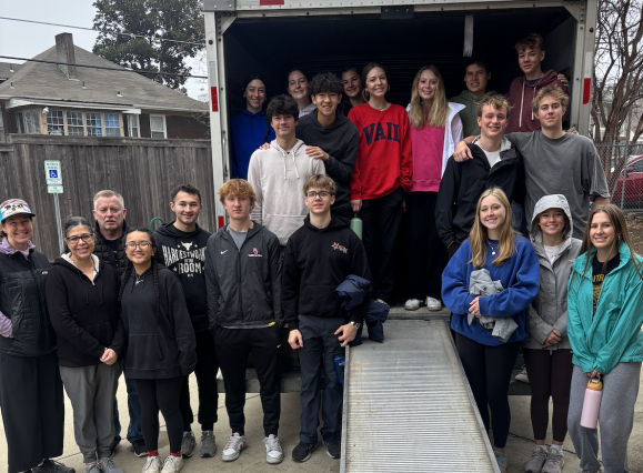 college students post for photo with moving truck