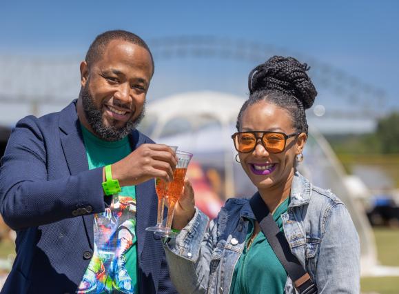 couple cheers glasses if mimosas