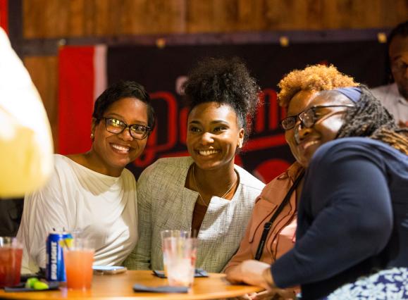 Three women smile for photo at Old Dominick