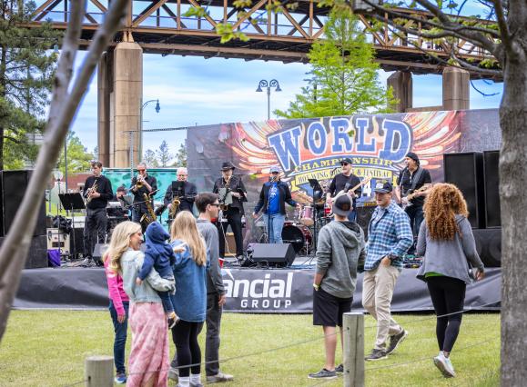 music stage set up at hot wing festival with crowd watching band performing