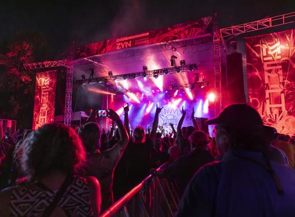 viewpoint from fan at mempho music festival looking around stage lit up in pink and red