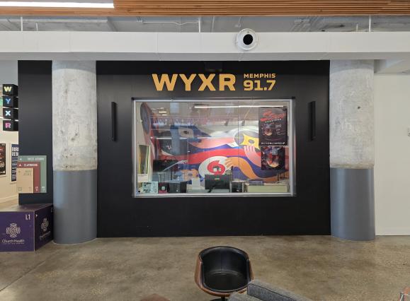 exterior of WYXR radio booth in crosstown concourse that is visible to the public