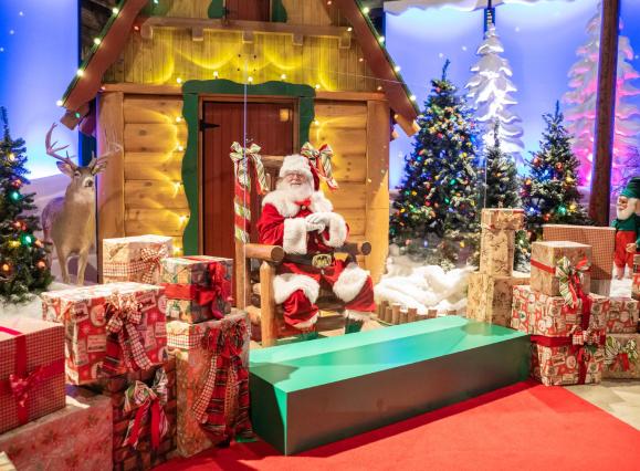 Santa's Wonderland at Bass Pro Shops at the Pyramid with Santa sitting in his chair surrounded by presents.