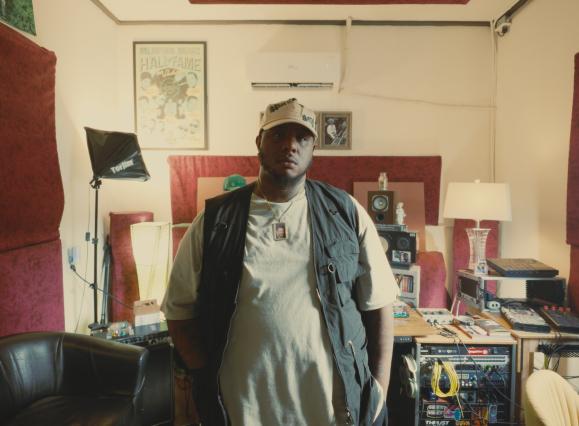 African American Man standing in front of recording equipment with his hands in pockets