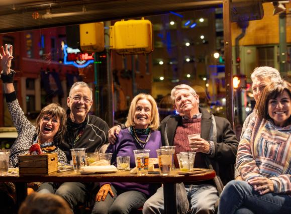 group of friends sitting and have drinks and smiling