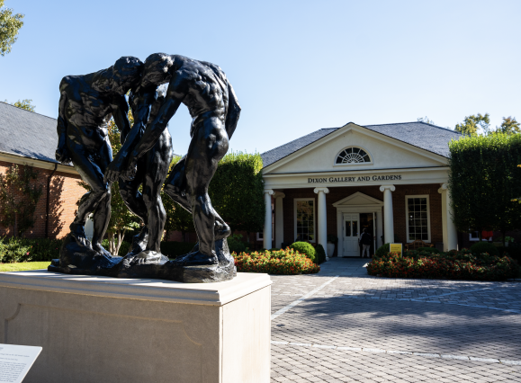 dixon exterior entrance with statue of three people hunched over 