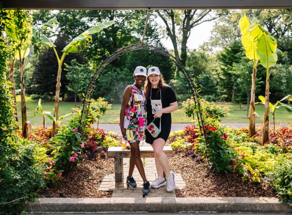 two women pose for photo in garden