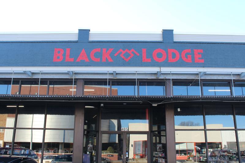Red and black sign exterior of Black Lodge video rental store