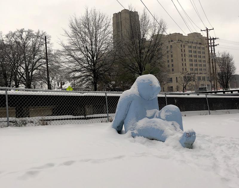 blue man statue at Crosstown with snow on the ground