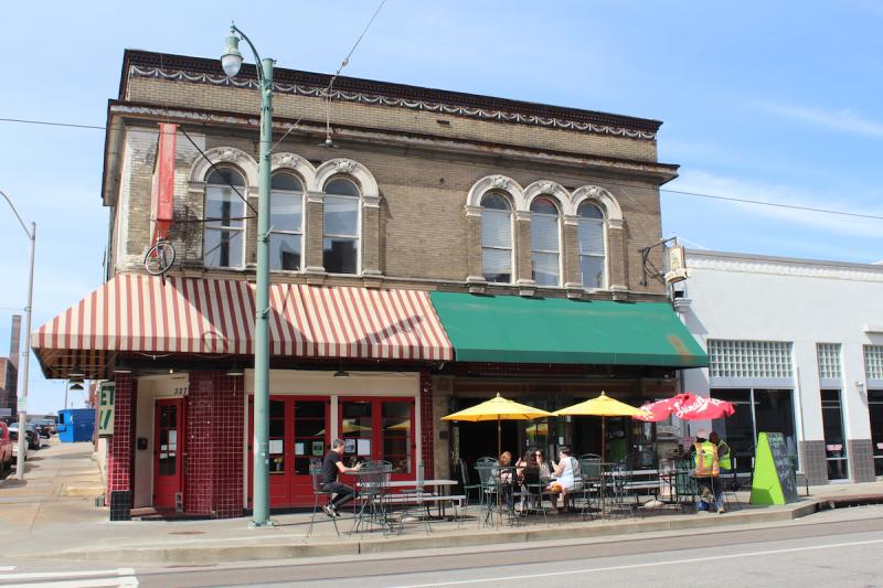 Historic Green Beetle bar building with red and green awning