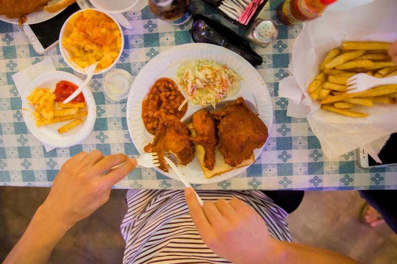 Girl eating Gus's Fried Chicken