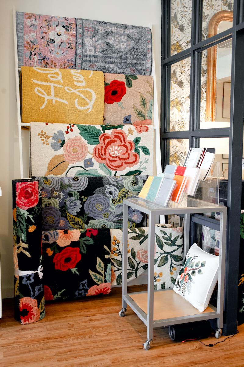 colorful door mats hanging up in gift shop