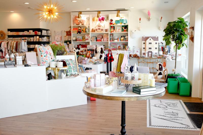 shop interior with tables of gifts and a dollhouse