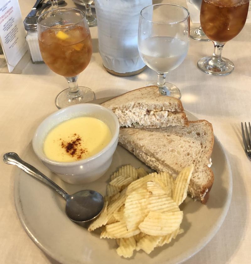 lunch plate of corn chowder, chicken salad sandwich, and potato chips