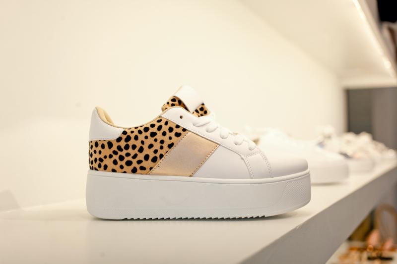 platform sneaker on a shelf, with diagonal strip of leopard print