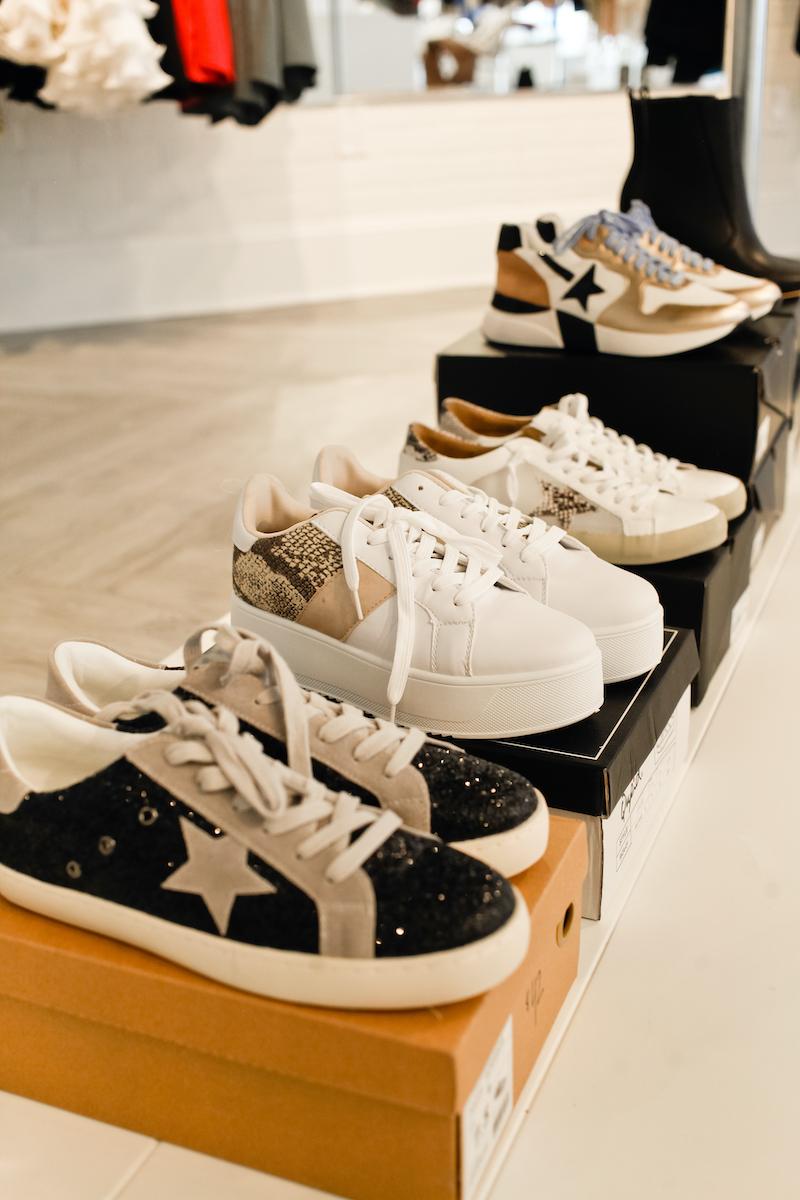 row of women's lace-up sneakers, including one with a star on the side