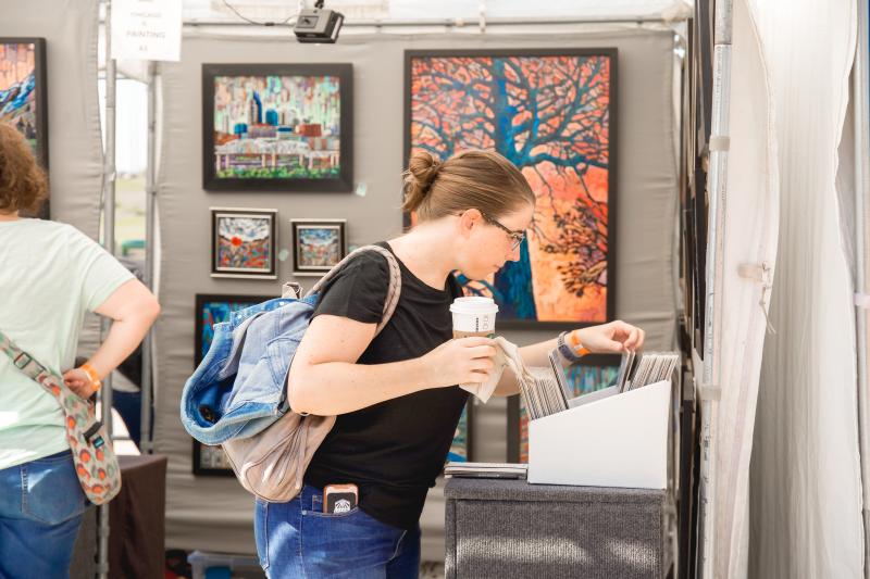 Someone shopping for art at RiverArtsFest.