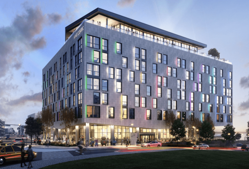 exterior view of Hyatt Centric hotel, rectangular building with colorful lights emanating from windows | Hyatt