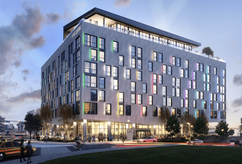exterior view of Hyatt Centric hotel, rectangular building with colorful lights emanating from windows | Hyatt