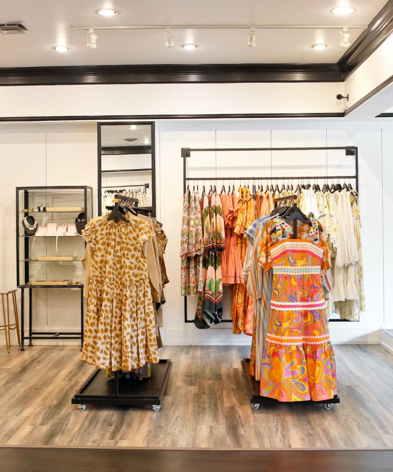 summer dresses (orange and gold colored) on display
