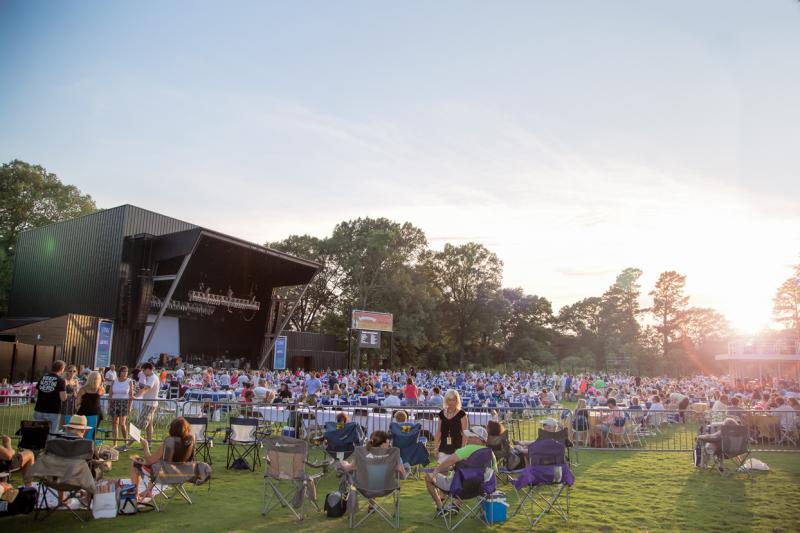 crowd of people on grassy lawn at Botanic Garden with music stage