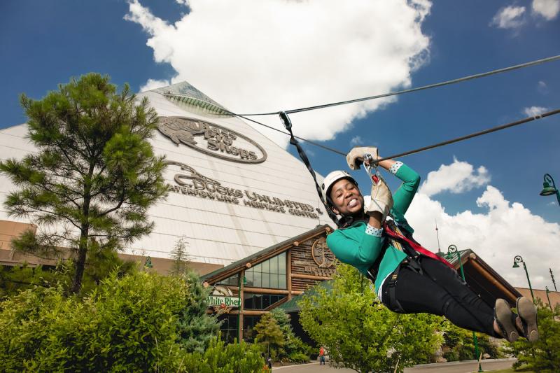 fake image for a joke of a woman ziplining down the pyramid, this is not a real thing you can do