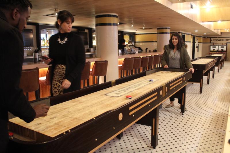 shuffleboard game in basement bar