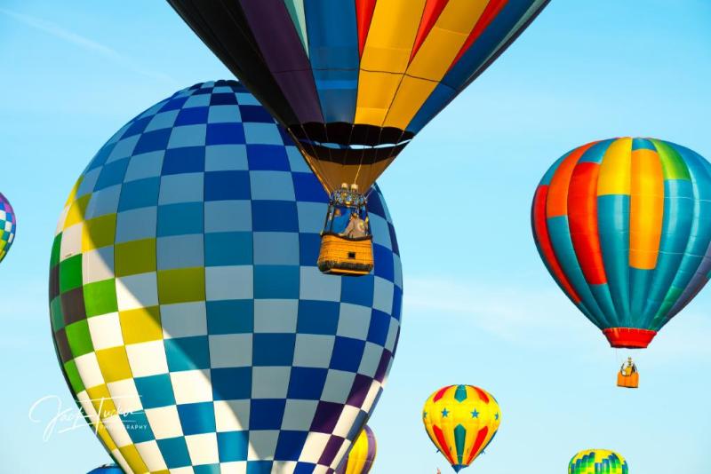 colorful hot air balloons floating through blue sky